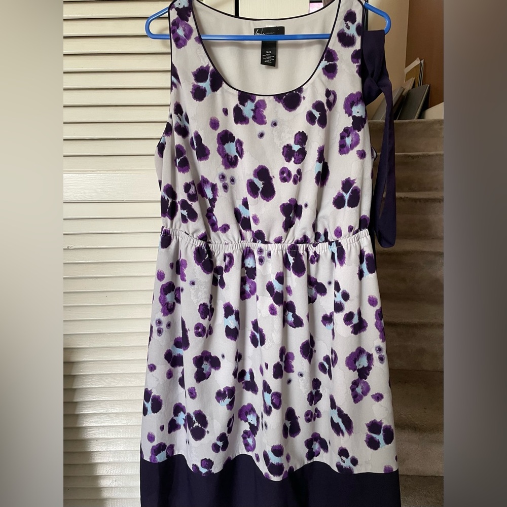 Purple sleeveless dress with belt.
